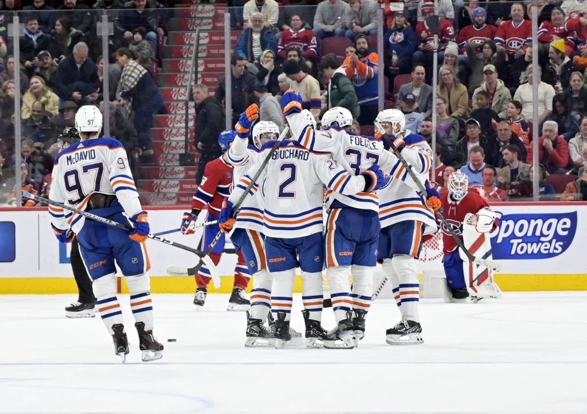 Jan 13, 2024; Montreal, Quebec, CAN; Edmonton Oilers defenseman Evan Bouchard (2) celebrates with teammates after scoring the winning goal against the Montreal Canadiens during the overtime period at the Bell Centre.