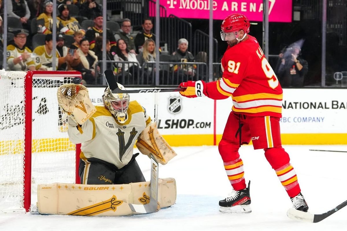 Jan 13, 2024; Las Vegas, Nevada, USA; Calgary Flames center Nazem Kadri (91) attempts to deflect a shot towards Vegas Golden Knights goaltender Logan Thompson (36) during the first period at T-Mobile Arena.
