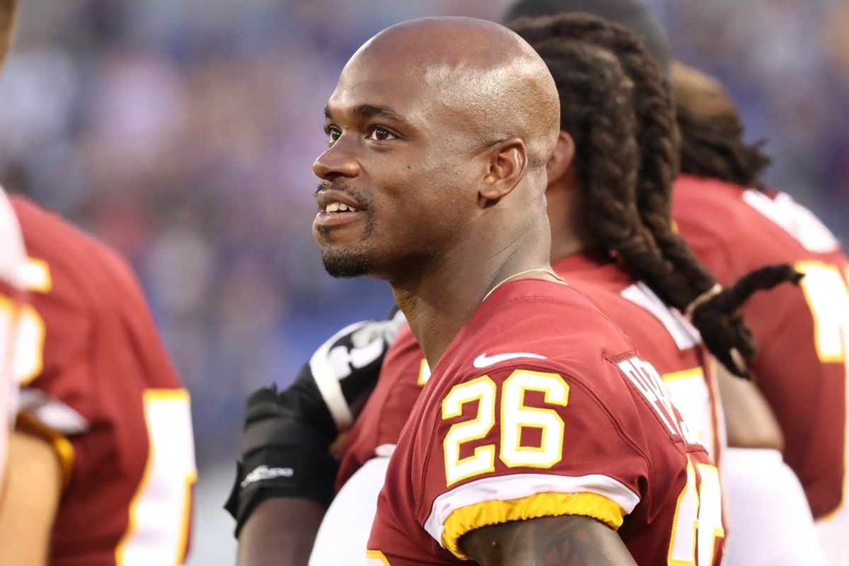 Aug 30, 2018; Baltimore, MD, USA; Washington Redskins running back Adrian Peterson (26) watches the scoreboard during the National Anthem prior to the game against the Baltimore Ravens at M&T Bank Stadium. Mandatory Credit: Mitch Stringer-Imagn Images