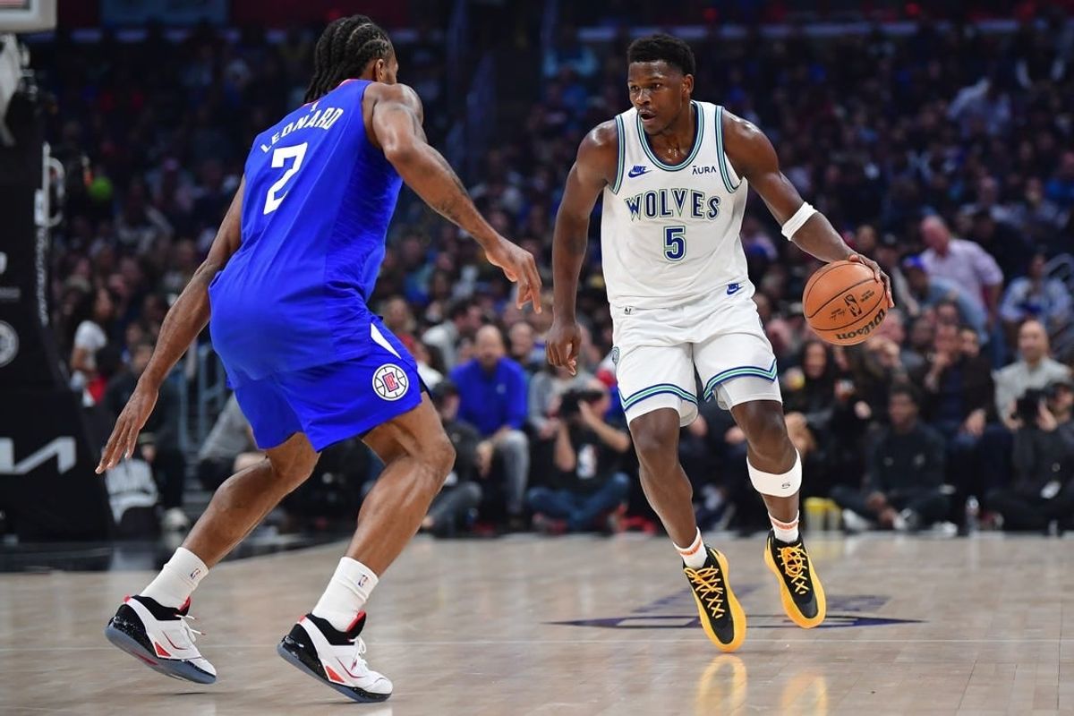Feb 12, 2024; Los Angeles, California, USA; Minnesota Timberwolves guard Anthony Edwards (5) controls the ball against Los Angeles Clippers forward Kawhi Leonard (2) during the first half at Crypto.com Arena.