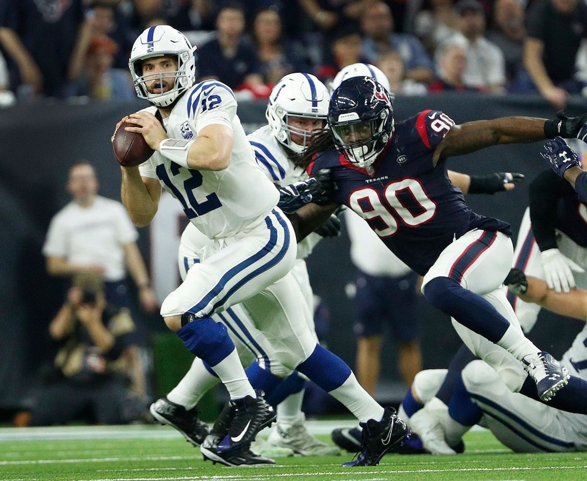 Indianapolis Colts quarterback Andrew Luck (12) runs away from Houston Texans outside linebacker Jadeveon Clowney (90) during their AFC Wild Card playoff game at NRG Stadium in Houston, TX., on Saturday, Jan. 5, 2019. The Indianapolis Colts defeated the Houston Texans 21-7

Indianapolis Colts Play At Houston Texans