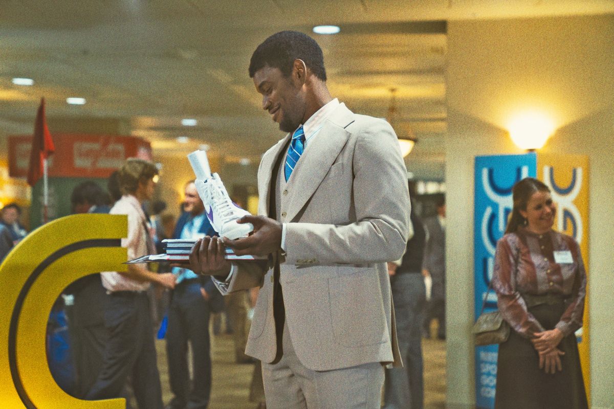 Magic Johnson (Quincy Isaiah) checks out some shoes.