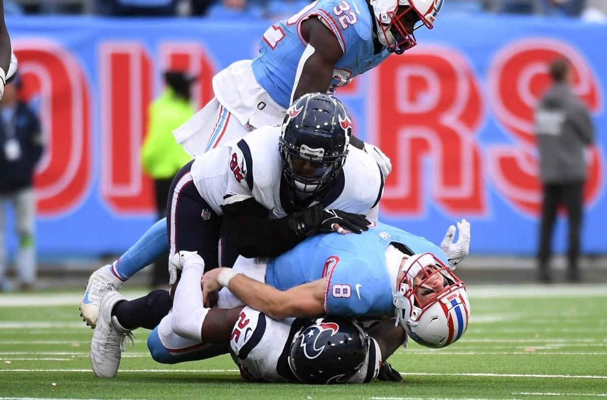 Dec 17, 2023; Nashville, Tennessee, USA; Tennessee Titans quarterback Will Levis (8) is injured after being sacked by Houston Texans cornerback Desmond King II (25) defensive tackle Sheldon Rankins (98) in overtime at Nissan Stadium.