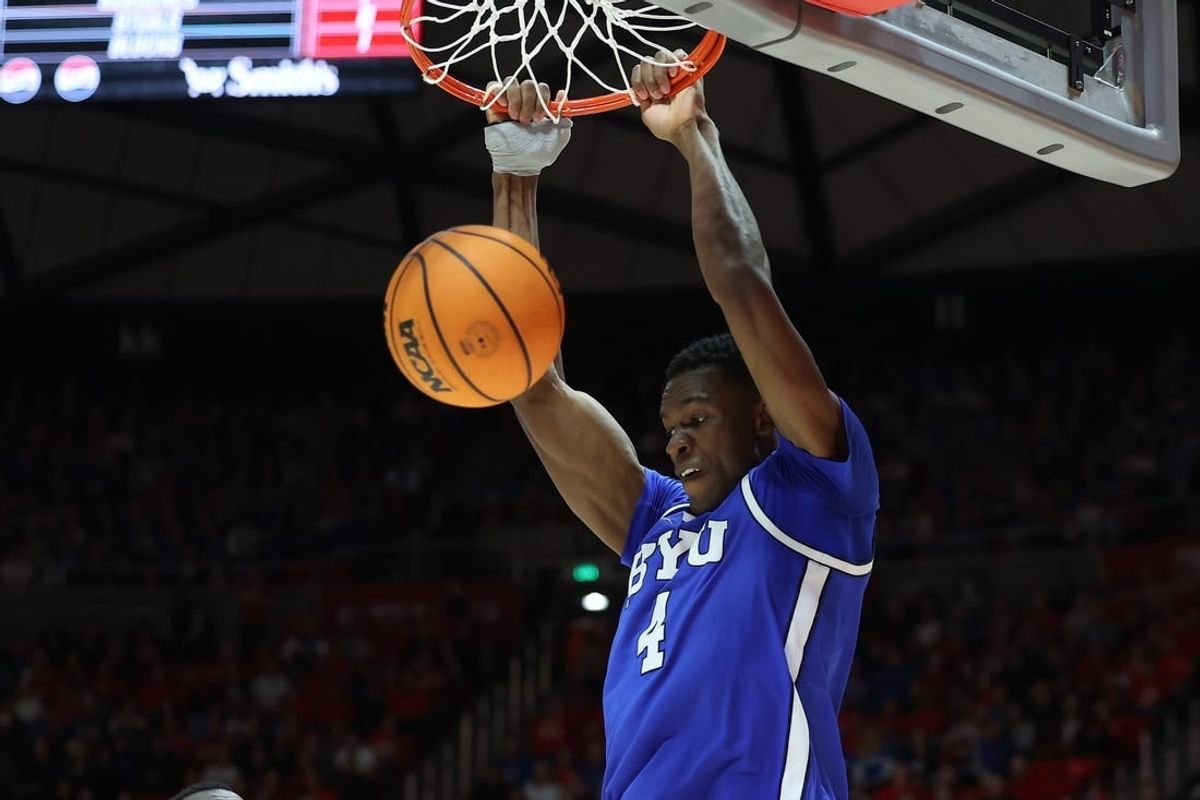 Dec 9, 2023; Salt Lake City, Utah, USA; Brigham Young Cougars forward Atiki Ally Atiki (4) dunks the ball against the Utah Utes during the first half at Jon M. Huntsman Center.
