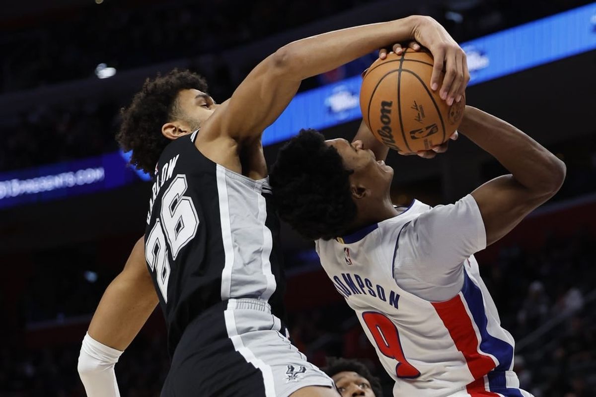 Jan 10, 2024; Detroit, Michigan, USA;  San Antonio Spurs forward Dominick Barlow (26) blocks a shot by Detroit Pistons forward Ausar Thompson (9) in the first half at Little Caesars Arena.