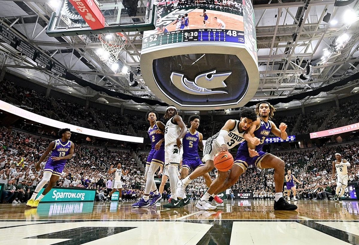 Nov 6, 2023; East Lansing, Michigan, USA; Michigan State Spartans guard Jaden Akins (3) battles with James Madison Dukes forward T.J. Bickerstaff (3) for a loose ball at Jack Breslin Student Events Center.