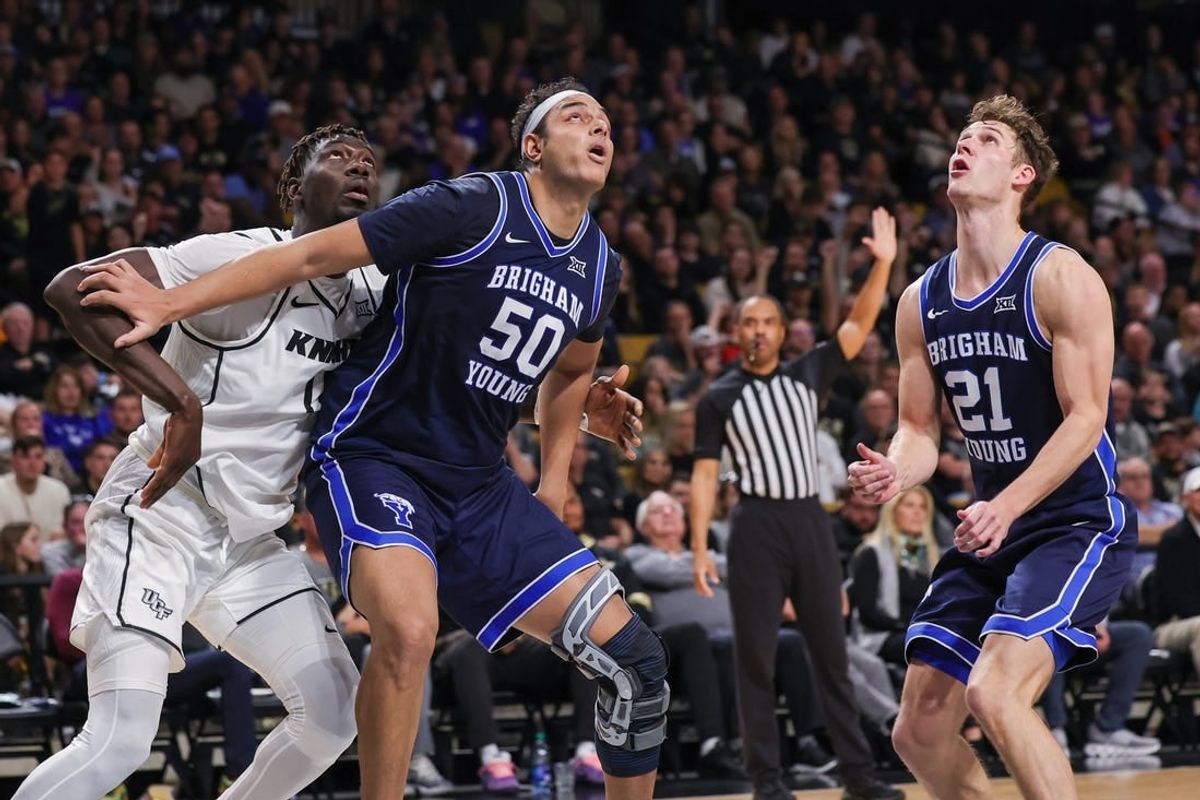 Jan 13, 2024; Orlando, Florida, USA; Brigham Young Cougars center Aly Khalifa (50) guard Trevin Knell (21) and UCF Knights forward Ibrahima Diallo (11) look for the rebound during the second half at Addition Financial Arena.