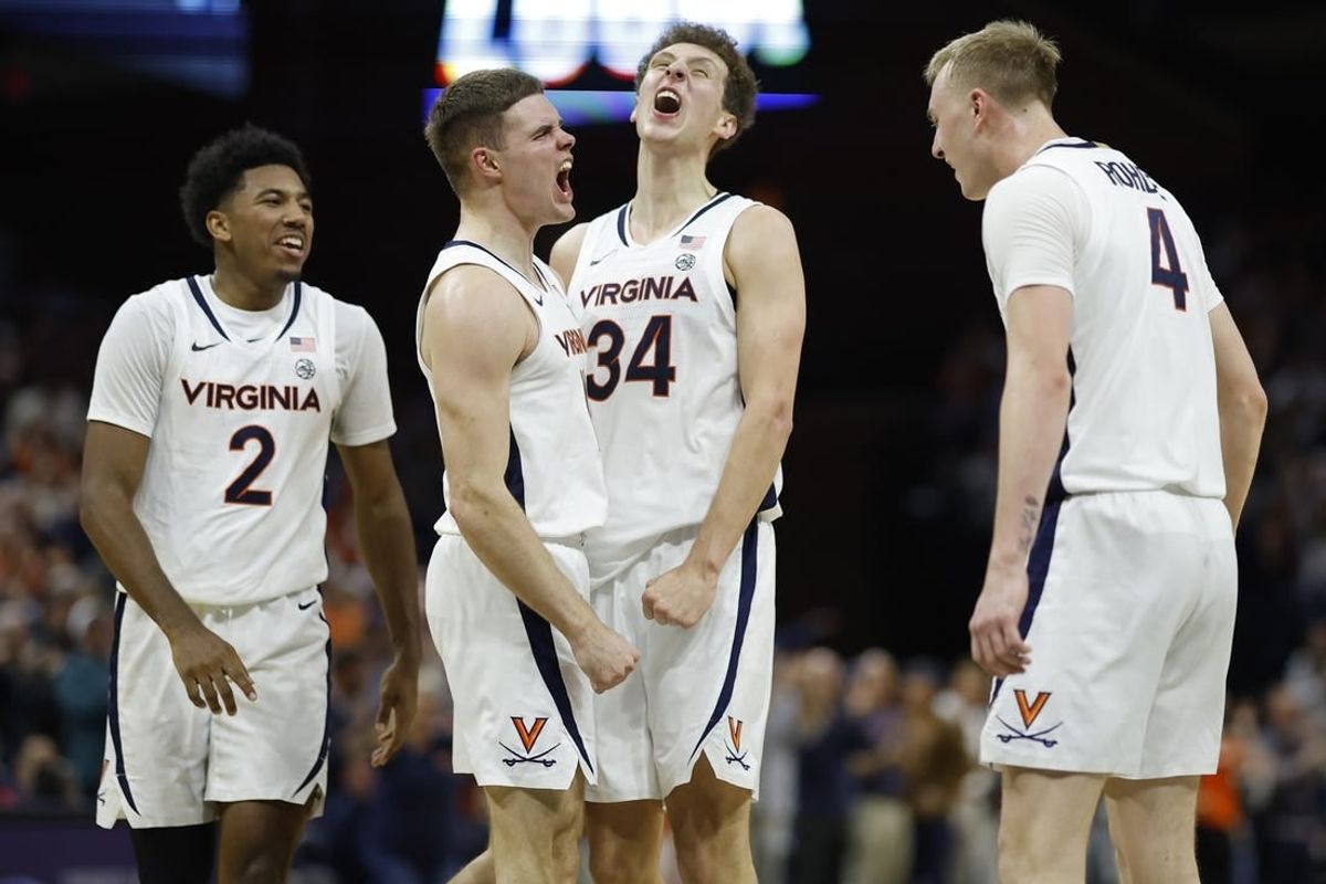 Dec 2, 2023; Charlottesville, Virginia, USA; Virginia Cavaliers guard Isaac McKneely (11) celebrates with teammates after a three point field goal against the Syracuse Orange during the first half at John Paul Jones Arena.