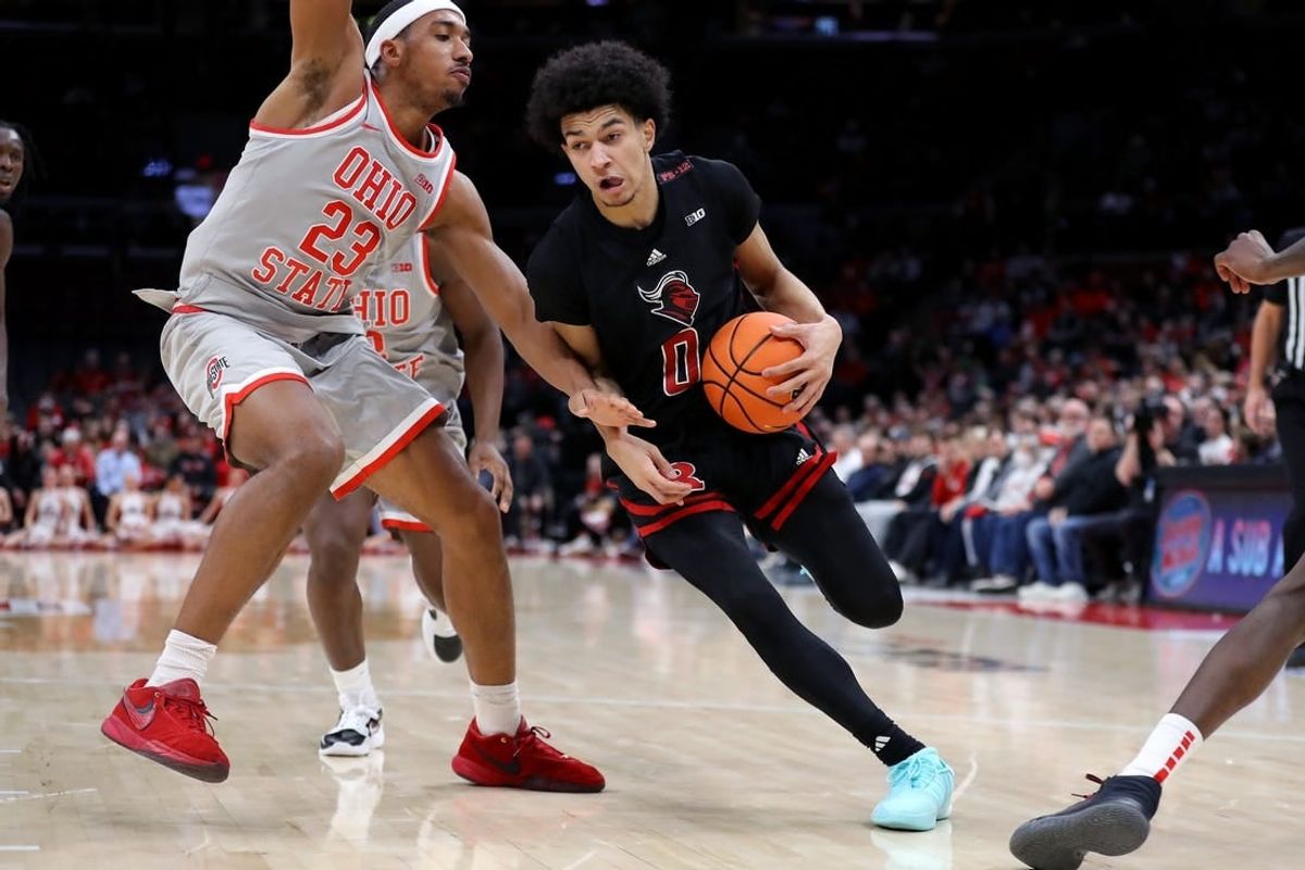 Jan 3, 2024; Columbus, Ohio, USA; Rutgers Scarlet Knights guard Derek Simpson (0) controls the ball as Ohio State Buckeyes forward Zed Key (23) defends during the first half at Value City Arena.