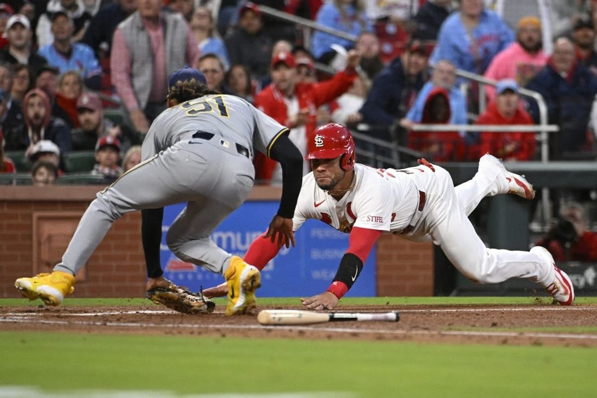 Apr 19, 2024; St. Louis, Missouri, USA; St. Louis Cardinals catcher Willson Contreras (40) slides into home plate and is tagged out by Milwaukee Brewers pitcher Freddy Peralta (51) in the second inning at Busch Stadium.