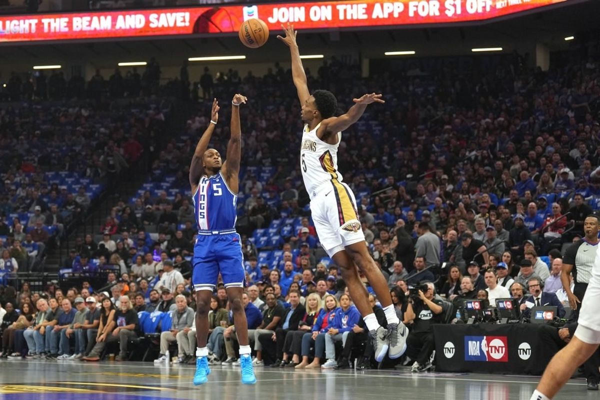 Dec 4, 2023; Sacramento, California, USA; Sacramento Kings guard De'Aaron Fox (5) shoots against New Orleans Pelicans forward Herbert Jones (5) during the first quarter at Golden 1 Center.