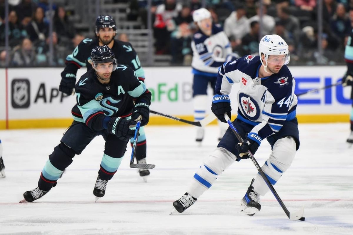 Mar 8, 2024; Seattle, Washington, USA; Winnipeg Jets defenseman Josh Morrissey (44) plays the puck while defended by Seattle Kraken right wing Jordan Eberle (7) during the second period at Climate Pledge Arena.