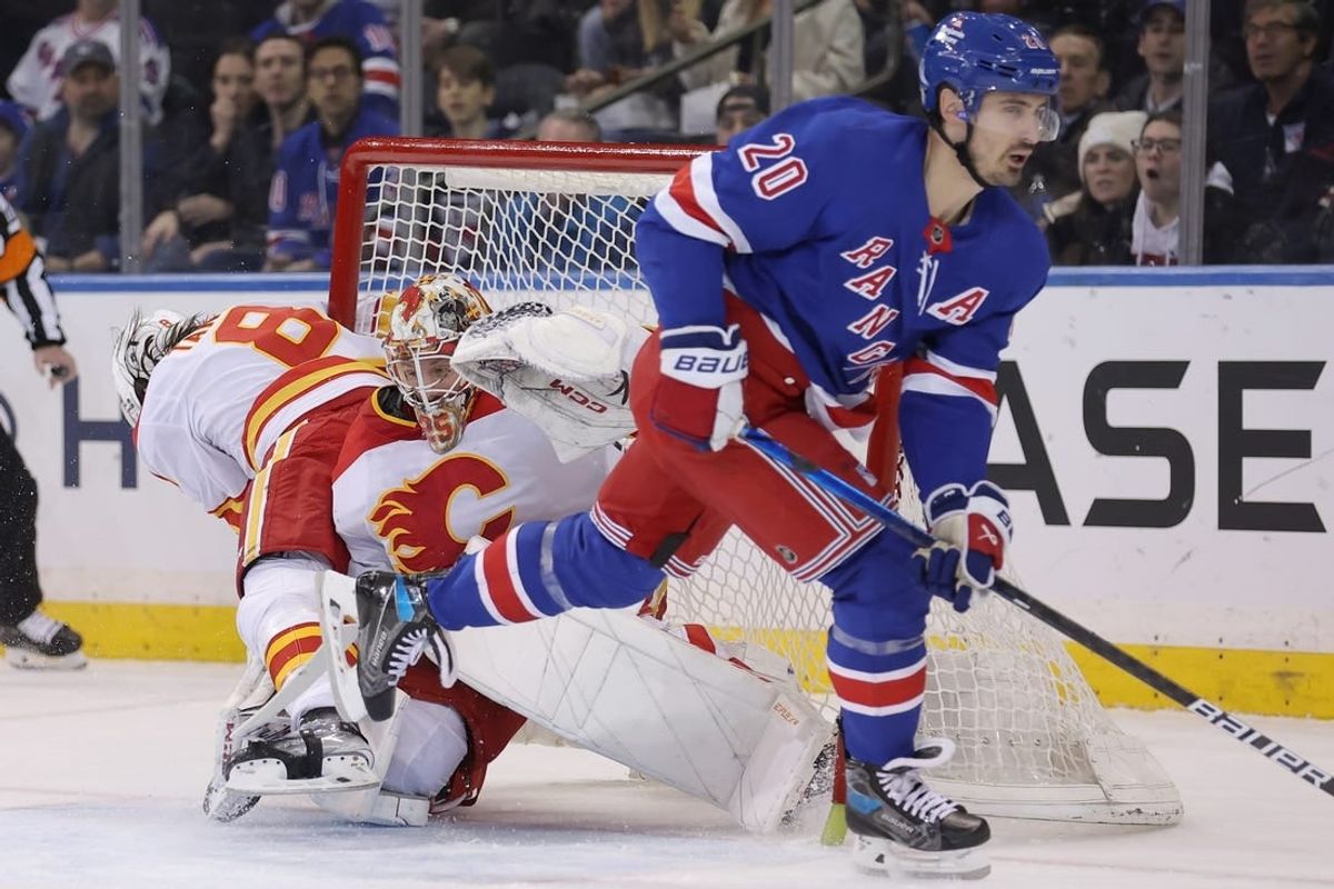 Feb 12, 2024; New York, New York, USA; Calgary Flames defenseman Chris Tanev (8) collides with goaltender Jacob Markstrom (25) as they fight for the puck against New York Rangers left wing Chris Kreider (20) during the first period at Madison Square Garden.