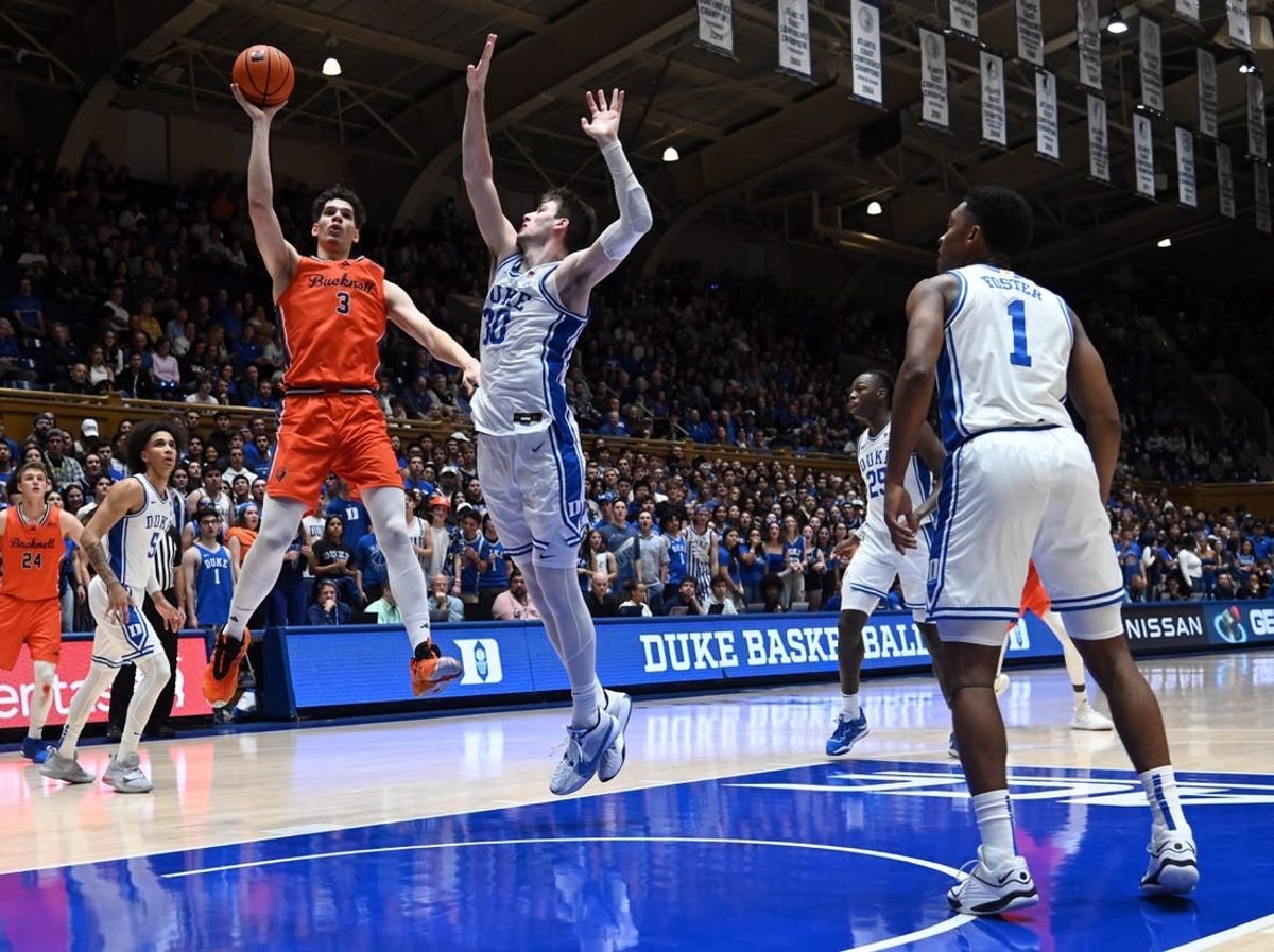 Nov 17, 2023; Durham, North Carolina, USA; Bucknell Bison forward Brady Muller (3) shoots over Duke Blue Devils center Kyle Filipowski(30) during the first half at Cameron Indoor Stadium.