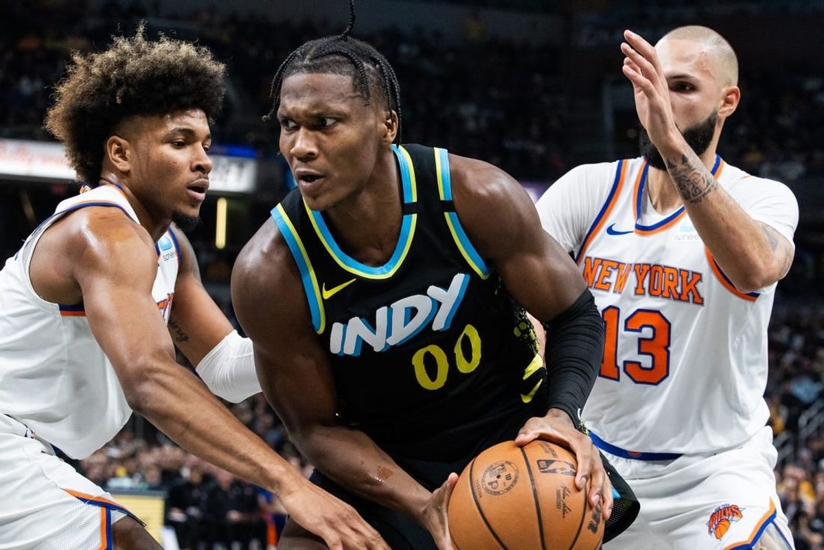 Dec 30, 2023; Indianapolis, Indiana, USA; Indiana Pacers guard Bennedict Mathurin (00) moves to shoot the ball whileNew York Knicks guard Miles McBride (2) and guard Evan Fournier (13)  defend in the second quarter at Gainbridge Fieldhouse.