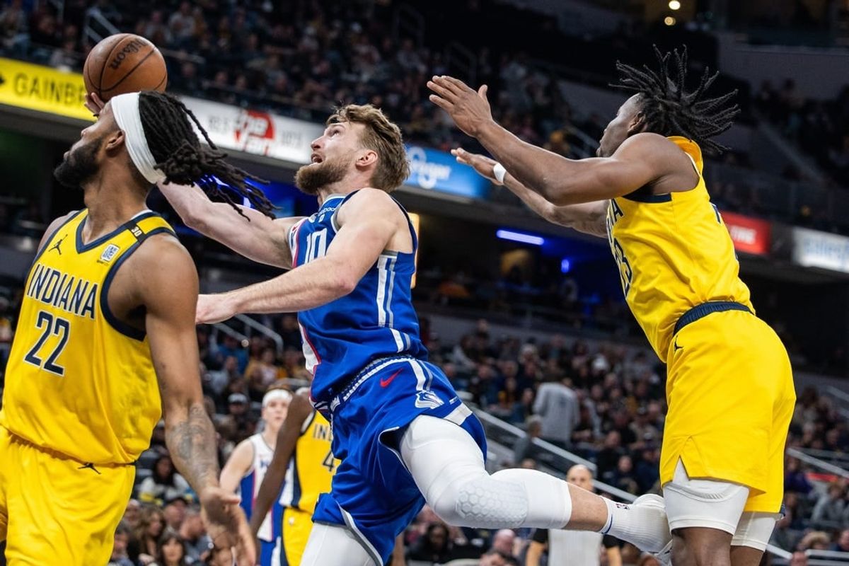 Feb 2, 2024; Indianapolis, Indiana, USA; Sacramento Kings forward Domantas Sabonis (10) shoots the ball while Indiana Pacers forward Isaiah Jackson (22) and forward Aaron Nesmith (23) defend in the second half at Gainbridge Fieldhouse.