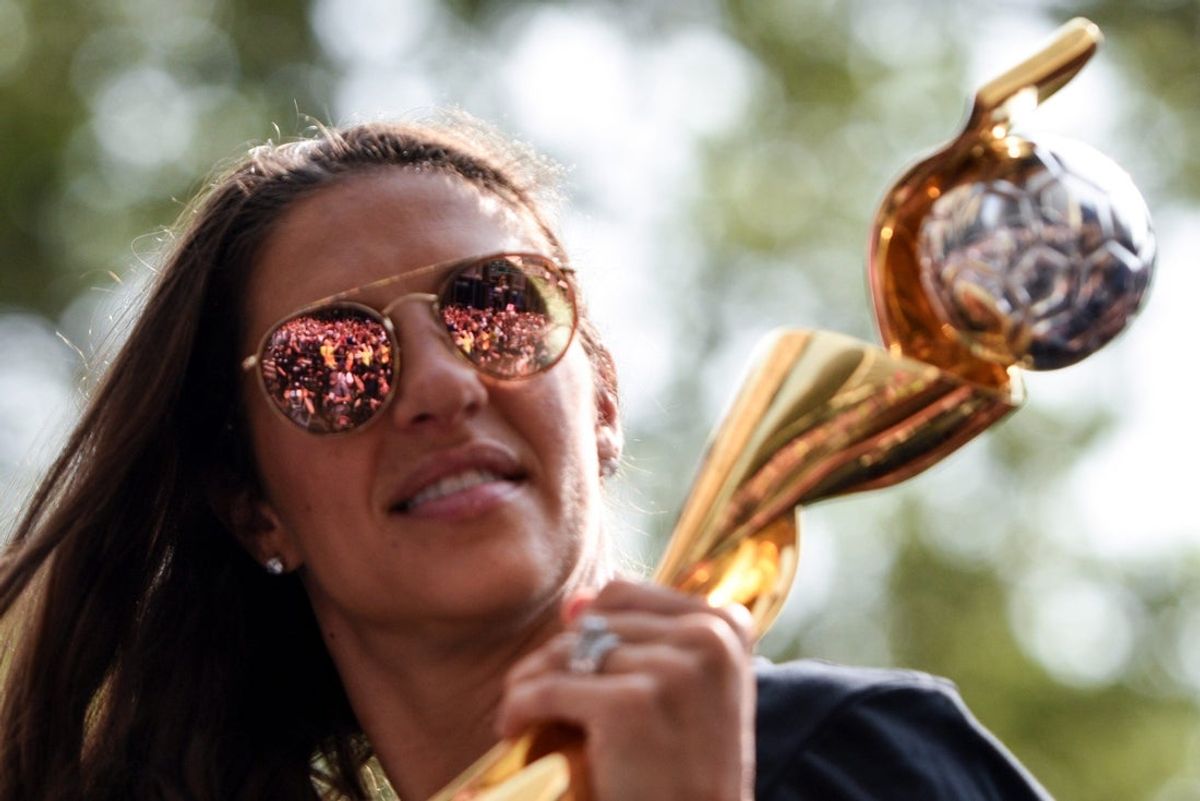 The crowd of fans is reflected in Carli Lloyd's sunglasses as she poses with the World Cup trophy. The U.S. Women's National Soccer Team celebrate their fourth World Cup win with a ticker tape parade down the Canyon of Heroes on Wednesday, July 10, 2019, in New York.

Xxx 071019 Uswntparade Dp 34 Jpg Usa Ny