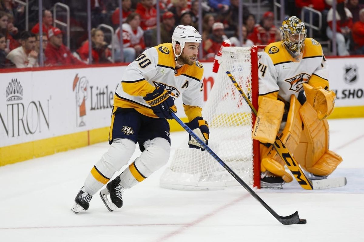 Dec 29, 2023; Detroit, Michigan, USA; Nashville Predators center Ryan O'Reilly (90) handles the puck during an overtime period of the game between the Detroit Red Wings and the Nashville Predators at Little Caesars Arena.