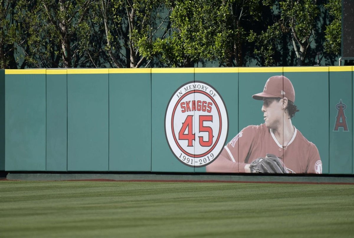 Jul 17, 2019; Anaheim, CA, USA; Detailed view of a memorial for Los Angeles Angels pitcher Tyler Skaggs on the outfield wall  at Angel Stadium of Anaheim. Skaggs, 27, died at a hotel in Southlake, Texas, July 1, 2019, where he was found unresponsive prior to a game against the Texas Rangers. Mandatory Credit: Kirby Lee-Imagn Images