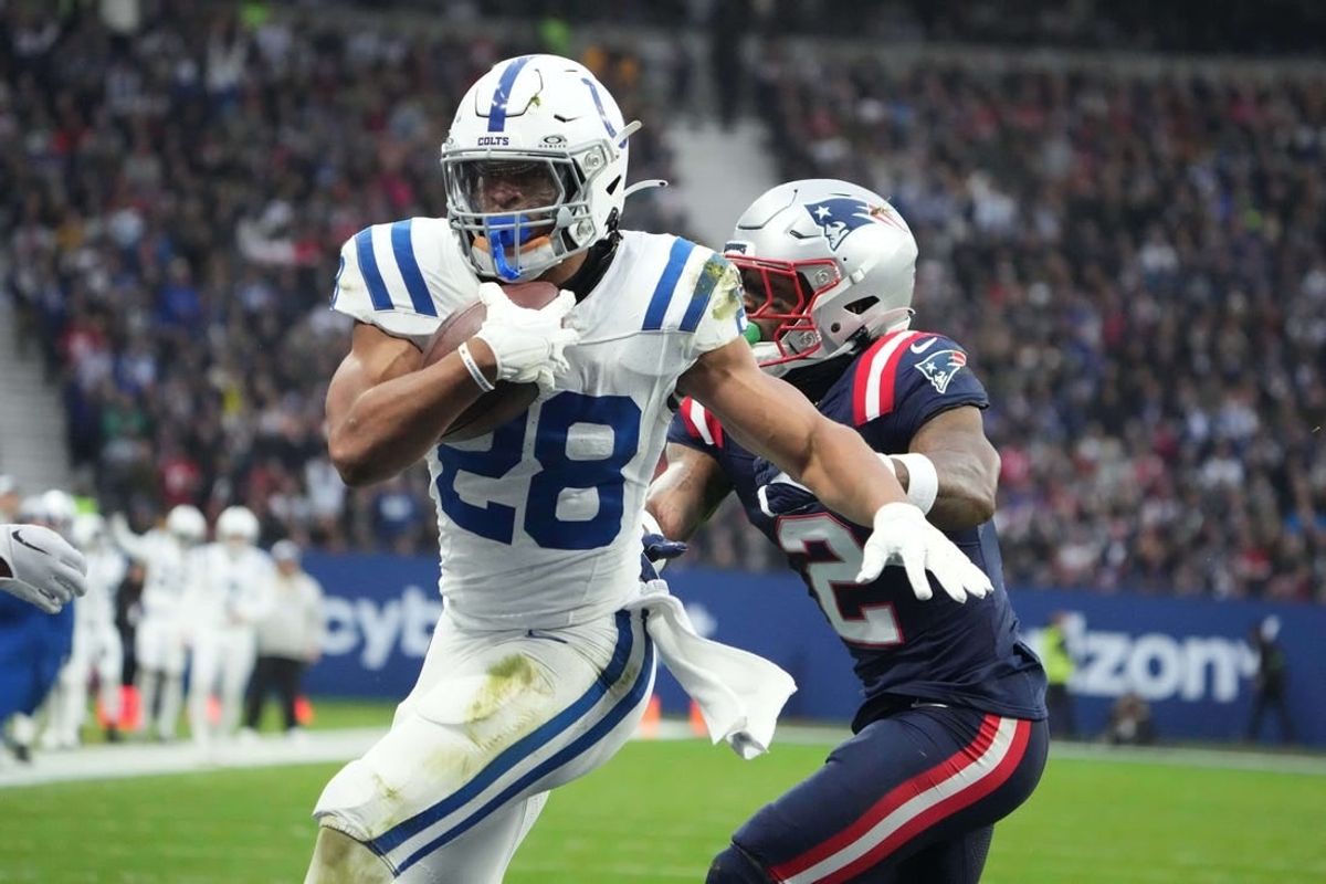 Nov 12, 2023; Frankfurt, Germany; Indianapolis Colts running back Jonathan Taylor (28) scores on a 1-yard touchdown run against New England Patriots cornerback Jalen Mills (2) in the first half during an NFL International Series game at Deutsche Bank Park.