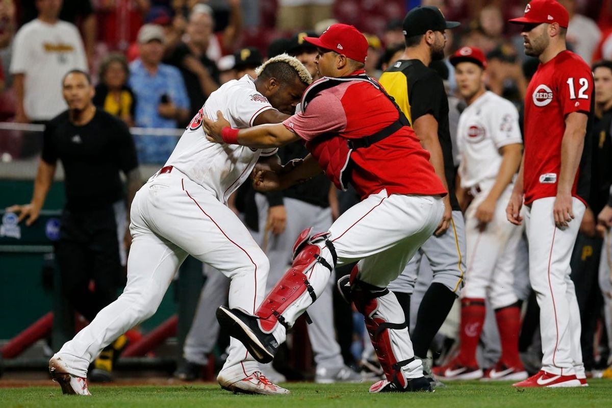 Cincinnati Reds right fielder Yasiel Puig (66) charges the Pittsburgh Pirates dugout again as a brawl disperses in the ninth inning of the MLB National League game between the Cincinnati Reds and the Pittsburgh Pirates at Great American Ball Park in downtown Cincinnati on Tuesday, July 30, 2019. The Pirates won 11-4.

Pittsburgh Pirates At Cincinnati Reds