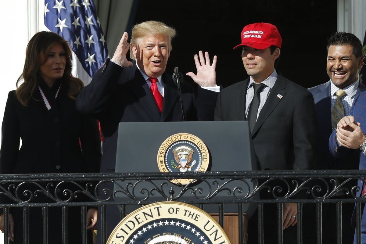 Nov 4, 2019; Washington, D.C., USA; President Donald Trump gestures while inviting Washington Nationals catcher Kurt Suzuki (R) to the podium during a ceremony honoring the 2019 World Series champion Nationals on the Truman Balcony on the South Lawn at The White House. Mandatory Credit: Geoff Burke-Imagn Images