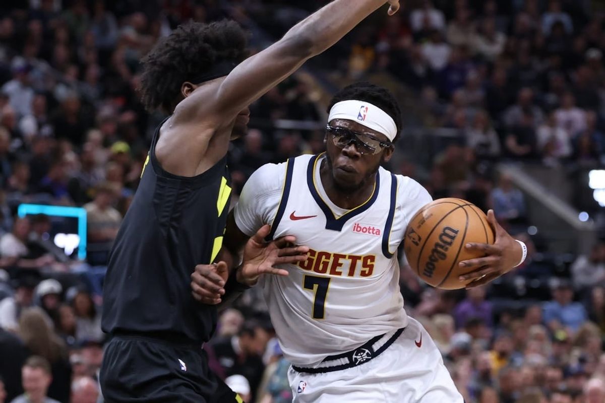 Apr 9, 2024; Salt Lake City, Utah, USA; Denver Nuggets guard Reggie Jackson (7) drives against Utah Jazz forward Taylor Hendricks (0) during the second quarter at Delta Center.