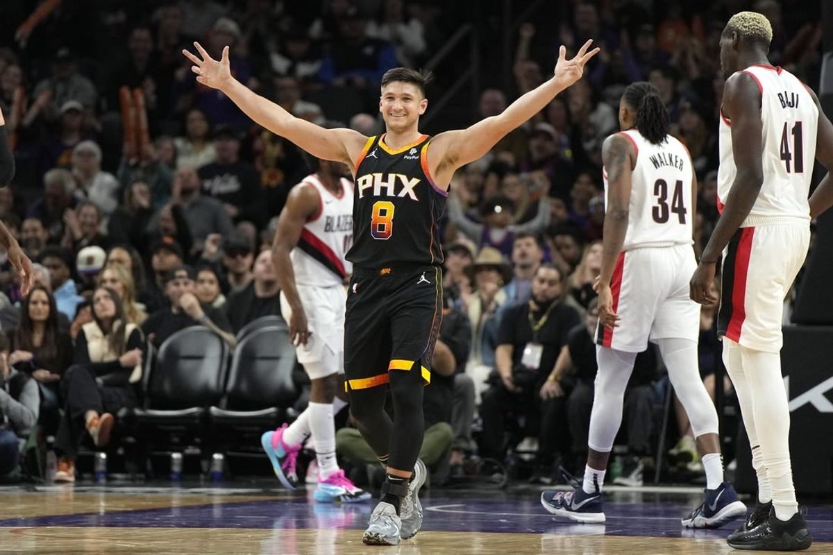 Jan 1, 2024; Phoenix, Arizona, USA; Phoenix Suns guard Grayson Allen (8) reacts after guard Devin Booker (1) makes a basket against the Portland Trail Blazers in the second half at Footprint Center.