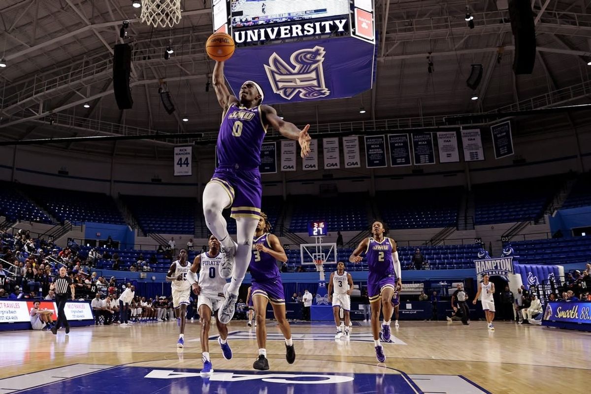 Dec 16, 2023; Hampton, Virginia, USA; James Madison Dukes guard Xavier Brown (0) dunks the ball against the Hampton Pirates during the second half at Hampton Convocation Center.