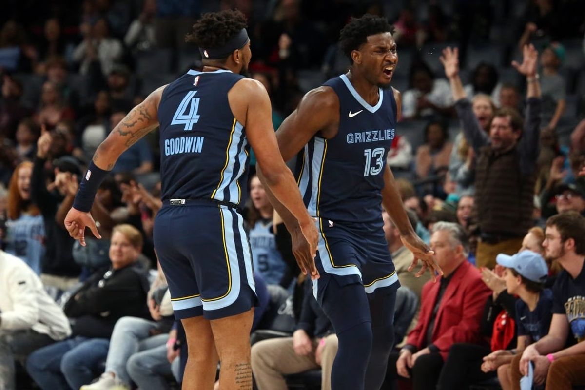 Feb 14, 2024; Memphis, Tennessee, USA; Memphis Grizzlies forward-center Jaren Jackson Jr. (13) reacts with guard Jordan Goodwin(4) after a three-point basket during the second half against the Houston Rockets at FedExForum.