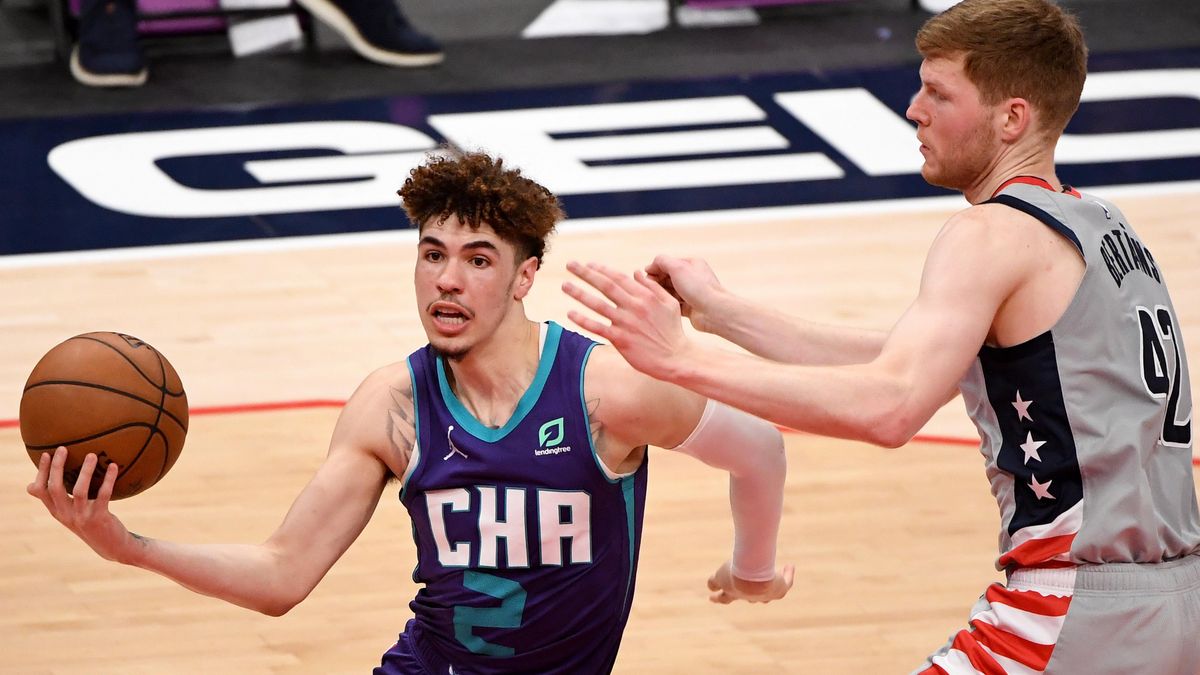 LaMelo Ball of the Charlotte Hornets looks to shoot in front of Davis Bertans of the Washington Wizards during the second half at Capital One Arena on May 16, 2021 in Washington, DC.