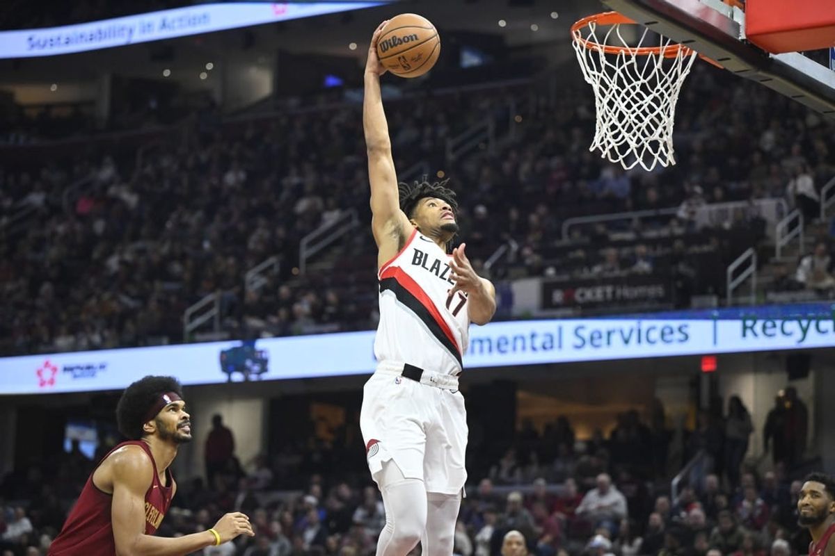 Nov 30, 2023; Cleveland, Ohio, USA; Portland Trail Blazers guard Shaedon Sharpe (17) dunks beside Cleveland Cavaliers center Jarrett Allen (31) in the second quarter at Rocket Mortgage FieldHouse.