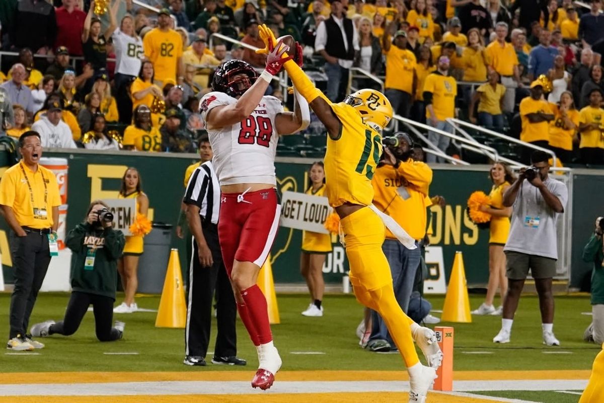 Oct 7, 2023; Waco, Texas, USA; Texas Tech Red Raiders tight end Baylor Cupp (88) makes a touchdown catch against Baylor Bears cornerback Caden Jenkins (19) during the first half at McLane Stadium.