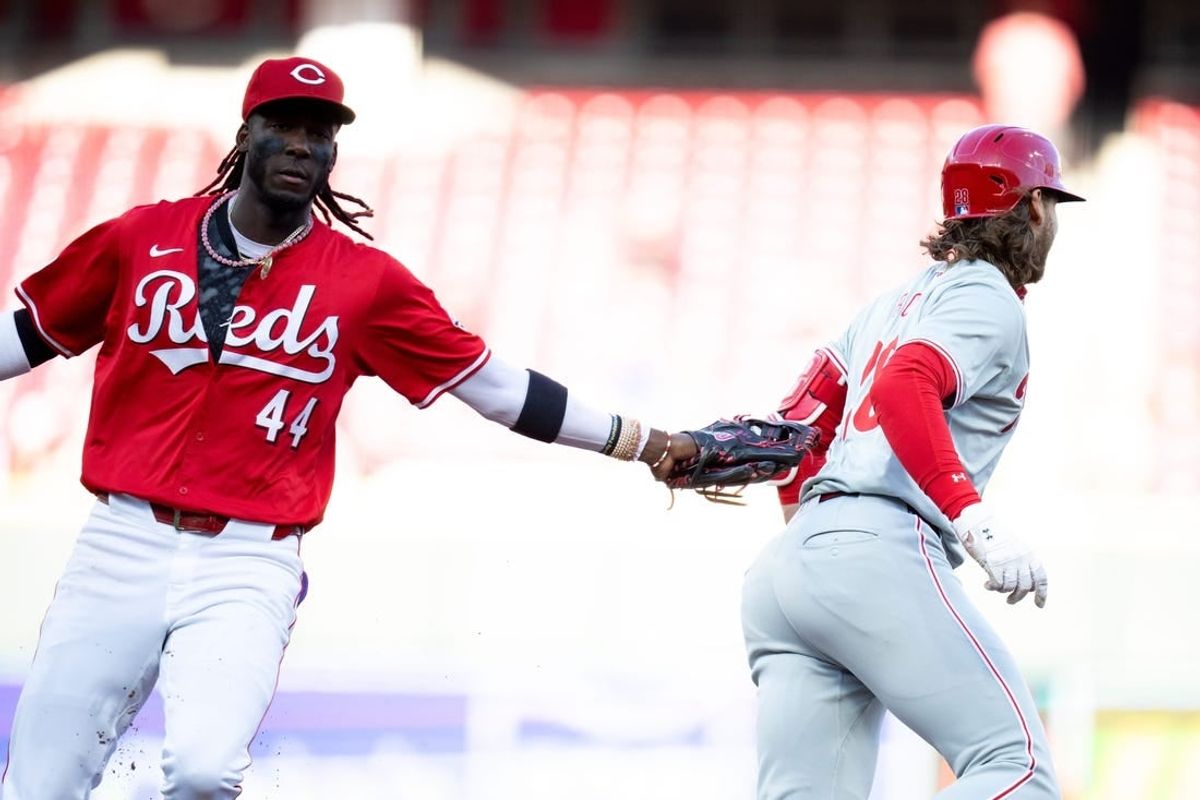 Cincinnati Reds shortstop Elly De La Cruz (44) tags out Philadelphia Phillies third base Alec Bohm (28) as he attempts to take second base on an RBI base hit in the first inning of the MLB baseball game between the Cincinnati Reds and the Philadelphia Phillies at Great American Ball Park in Cincinnati on Wednesday, April 24, 2024.