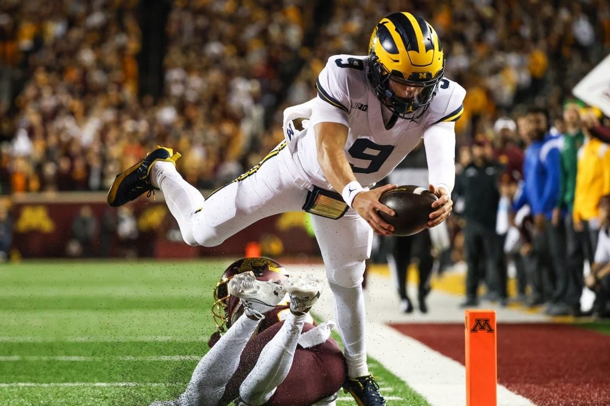 Oct 7, 2023; Minneapolis, Minnesota, USA; Michigan Wolverines quarterback J.J. McCarthy (9) dives for a  touchdown against the Minnesota Golden Gophers during the second quarter at Huntington Bank Stadium.