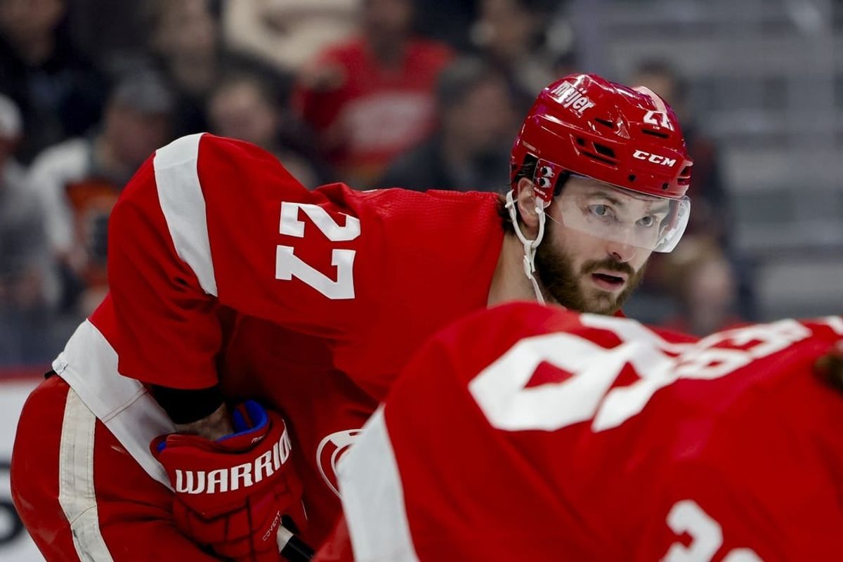 Jan 25, 2024; Detroit, Michigan, USA;  Detroit Red Wings center Michael Rasmussen (27) gets set during a face off in the first period against the Philadelphia Flyers at Little Caesars Arena.
