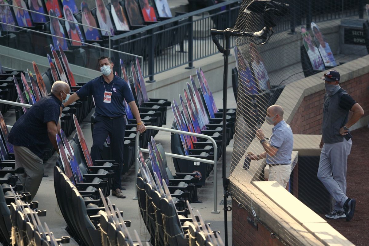 Jul 18, 2020; New York City, New York, USA; New York Mets general manager Brodie Van Wagenen (second from left) and special assistant Omar Minaya (left) talk to New York Yankees general manager Brian Cashman and manager Aaron Boone (right)  during batting practice before a preseason game at Citi Field. Mandatory Credit: Brad Penner-USA TODAY Sports