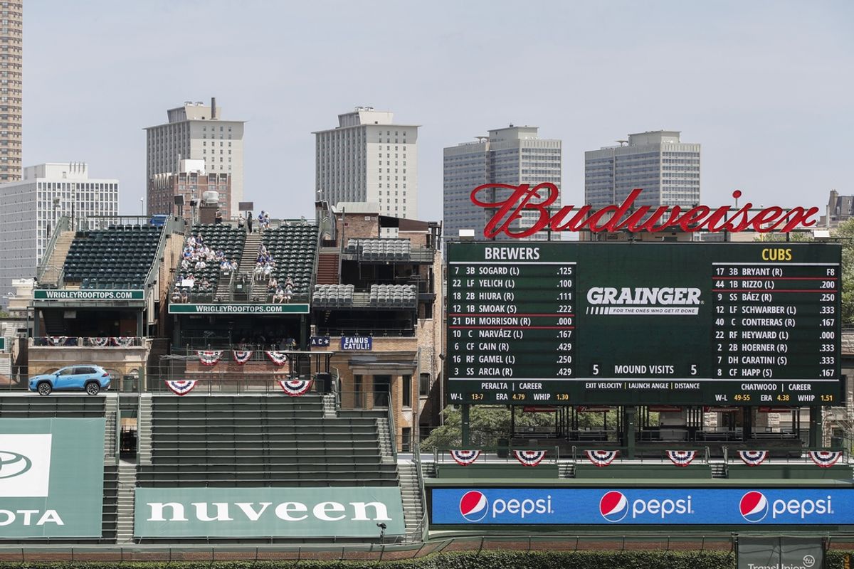 Jul 26, 2020; Chicago, Illinois, USA; Fans watch from Wrigley Rooftops MLB game between the Chicago Cubs and Milwaukee Brewers during the second inning at Wrigley Field. Mandatory Credit: Kamil Krzaczynski-USA TODAY Sports