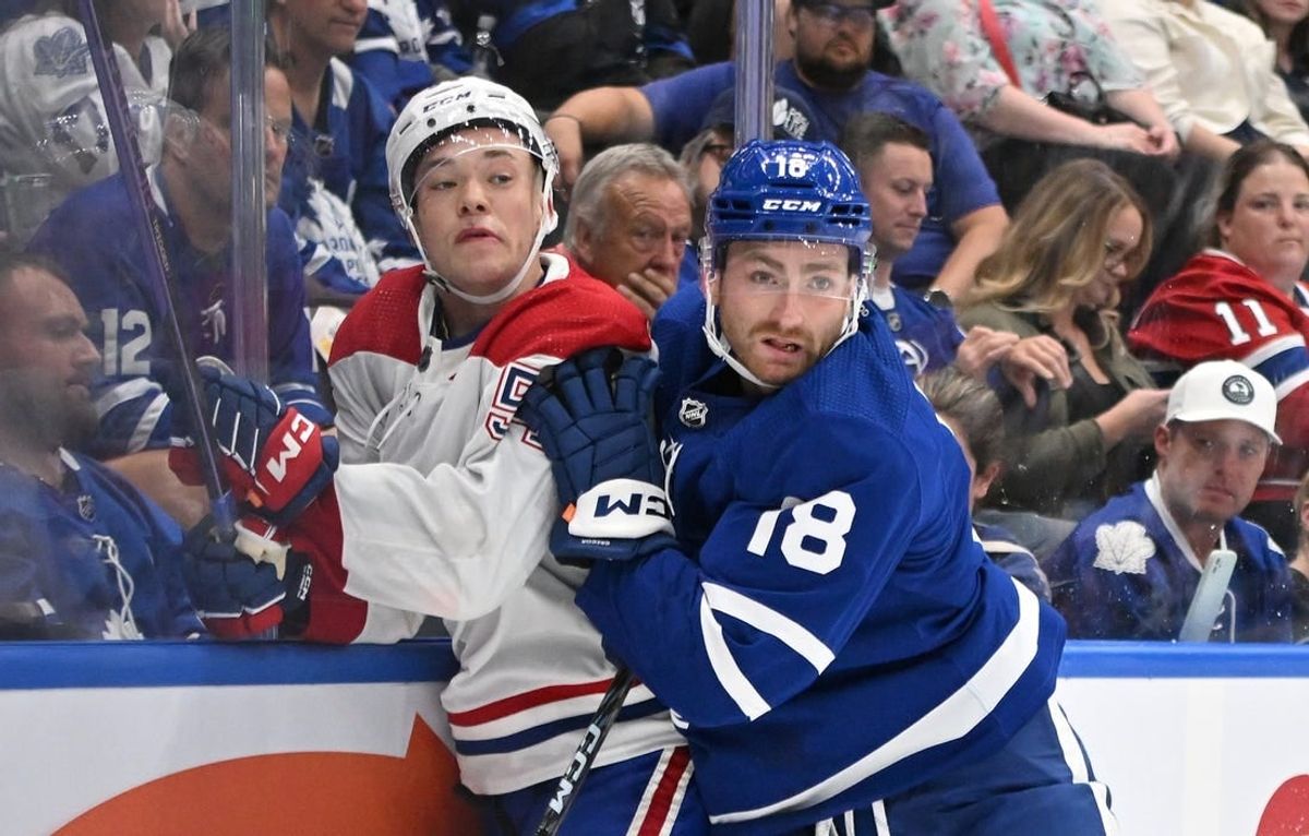 Oct 2, 2023; Toronto, Ontario, CAN;  Toronto Maple Leafs forward Noah Gregor (18) bodychecks Montreal Canadiens defenseman Jordan Harris (54) the third period at Scotiabank Arena.