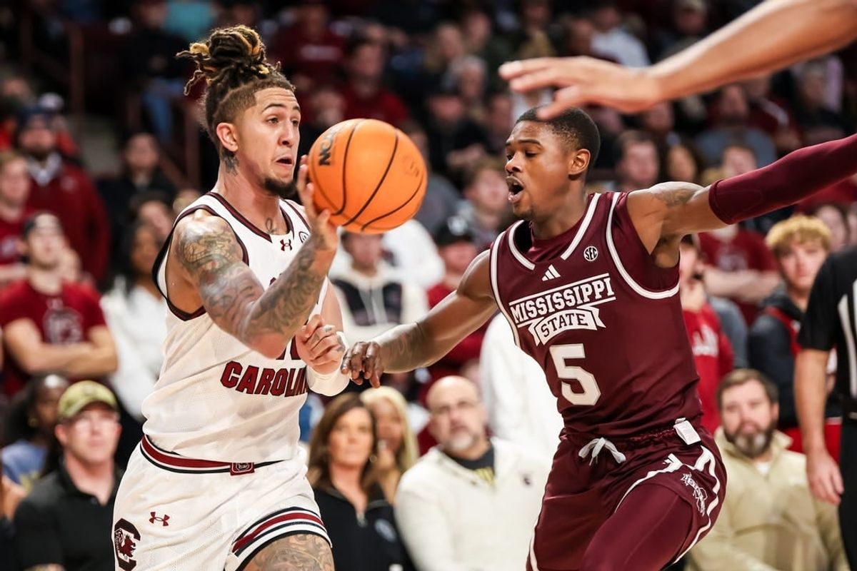 Jan 6, 2024; Columbia, South Carolina, USA; South Carolina Gamecocks guard Myles Stute (10) passes around Mississippi State Bulldogs guard Shawn Jones Jr. (5) in the first half at Colonial Life Arena.