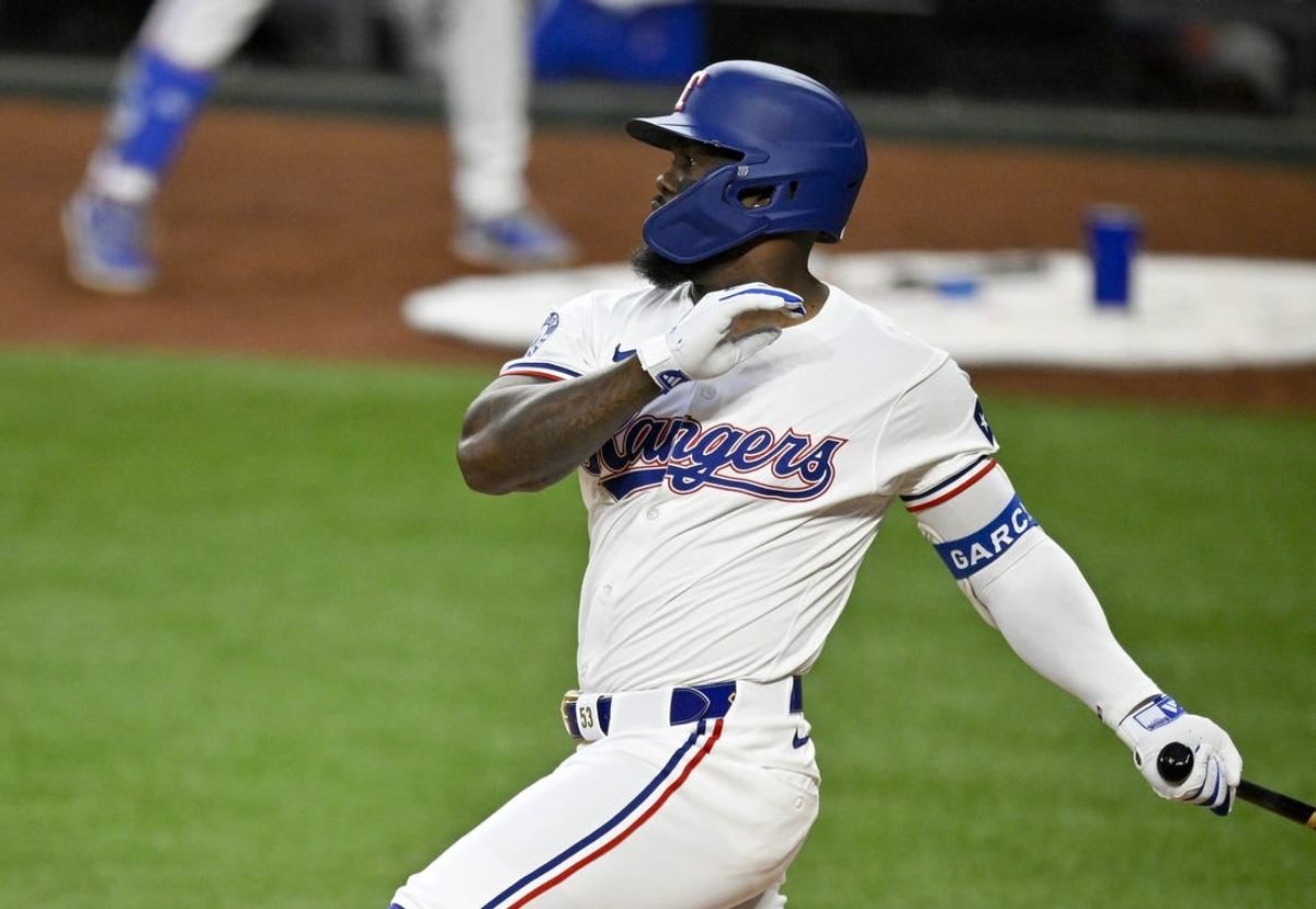 Apr 5, 2024; Arlington, Texas, USA; Texas Rangers right fielder Adolis Garcia (53) hits a three run home run against the Houston Astros during the second inning at Globe Life Field.