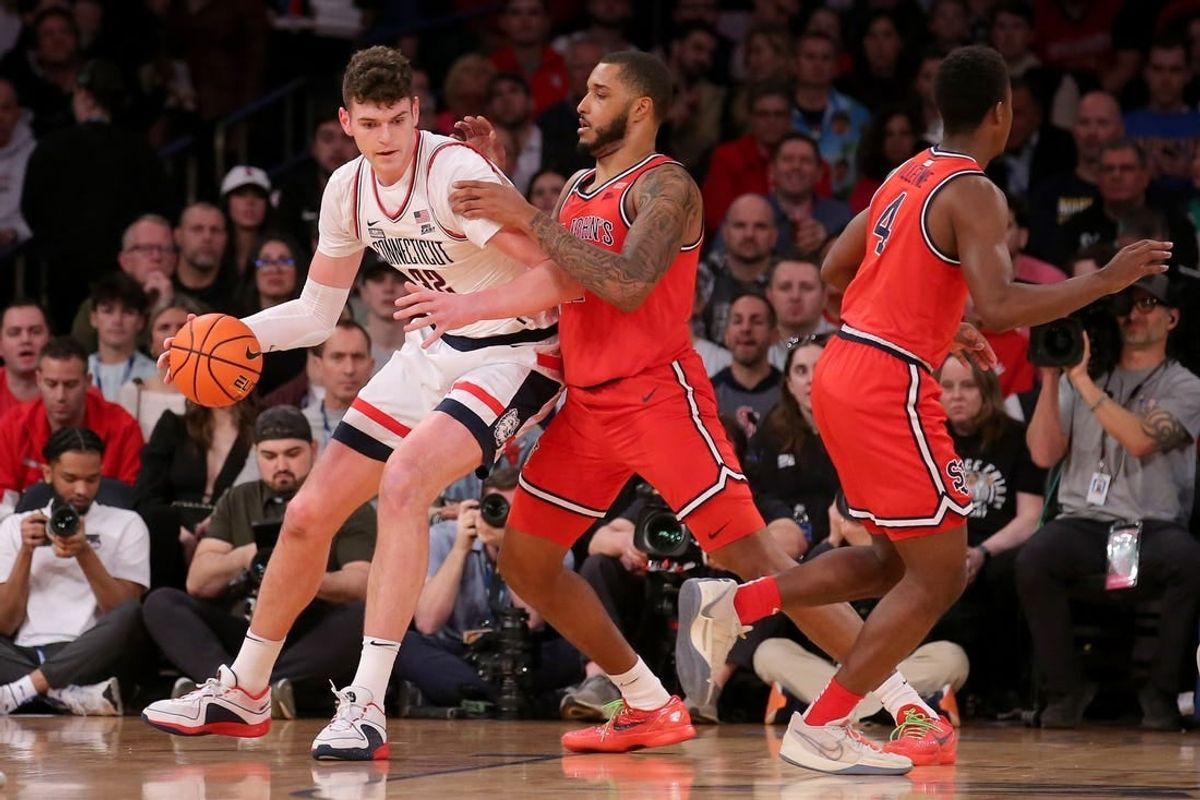 Mar 15, 2024; New York City, NY, USA; Connecticut Huskies center Donovan Clingan (32) controls the ball against St. John's Red Storm center Joel Soriano (11) and guard Nahiem Alleyne (4) during the first half at Madison Square Garden.