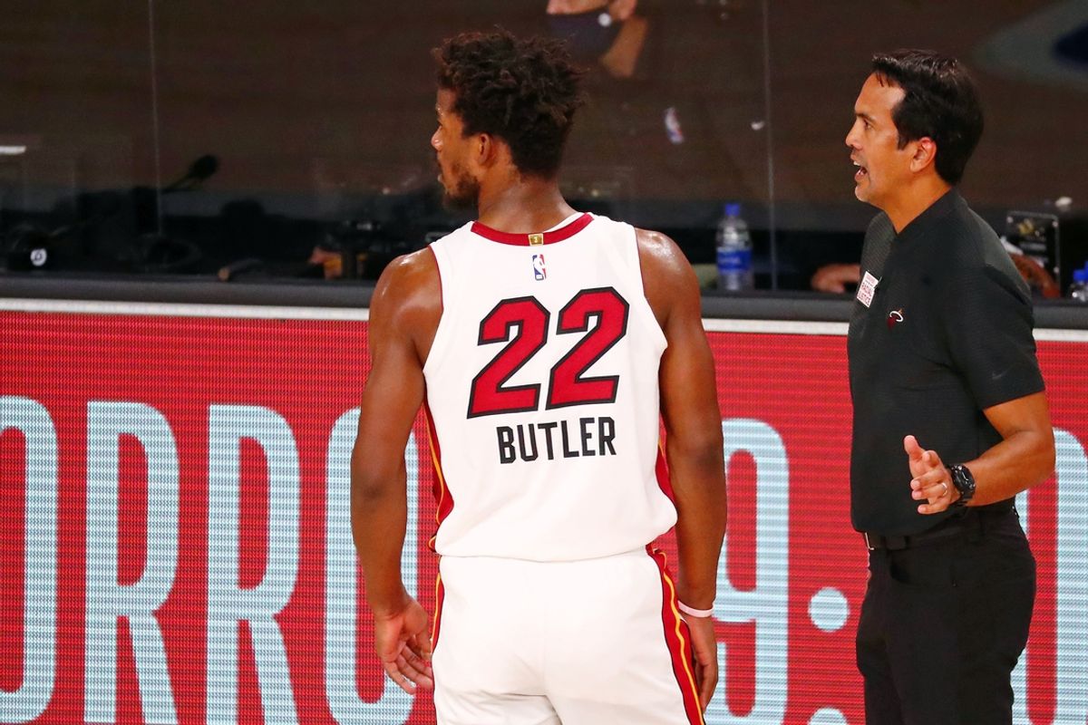 Sep 17, 2020; Lake Buena Vista, Florida, USA; Miami Heat forward Jimmy Butler (22) talks with head coach Erik Spoelstra during the fourth quarter in game two of the Eastern Conference Finals of the 2020 NBA Playoffs at ESPN Wide World of Sports Complex. The Miami Heat won 106-101. Mandatory Credit: Kim Klement-Imagn Images