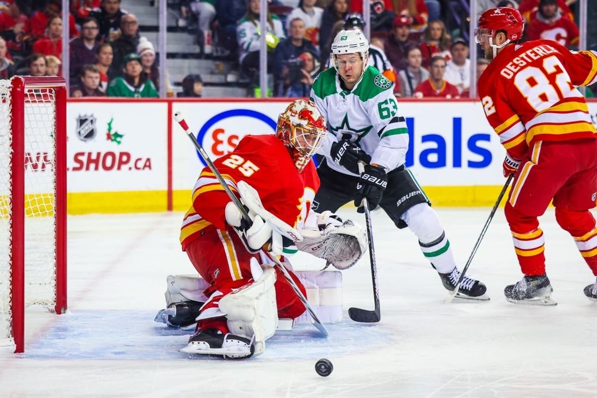 Nov 30, 2023; Calgary, Alberta, CAN; Calgary Flames goaltender Jacob Markstrom (25) makes a save against Dallas Stars right wing Evgenii Dadonov (63) during the first period at Scotiabank Saddledome.