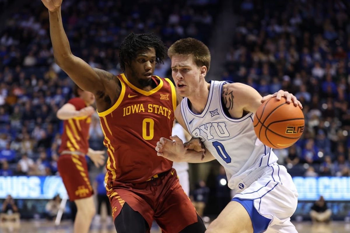 Jan 16, 2024; Provo, Utah, USA; Brigham Young Cougars forward Noah Waterman (0) drives to the basket against Iowa State Cyclones forward Tre King (0) during the first half at Marriott Center.