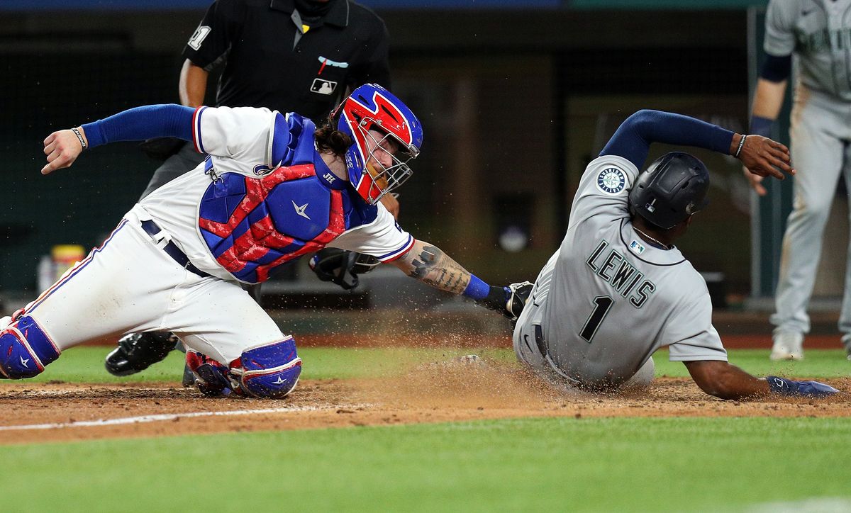 The Ra ngers got two cele bratio ns for the price of o ne as   Jonah Heim tagged out Kyle Lewis to e nd Saturday’s game.