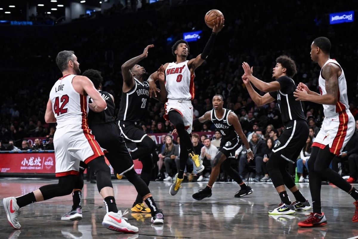 Nov 25, 2023; Brooklyn, New York, USA; Miami Heat guard Josh Richardson (0) drives to the basket against Brooklyn Nets forward Dorian Finney-Smith (28) and  guard Lonnie Walker IV (8) and forward Cameron Johnson (2) during the second quarter at Barclays Center.