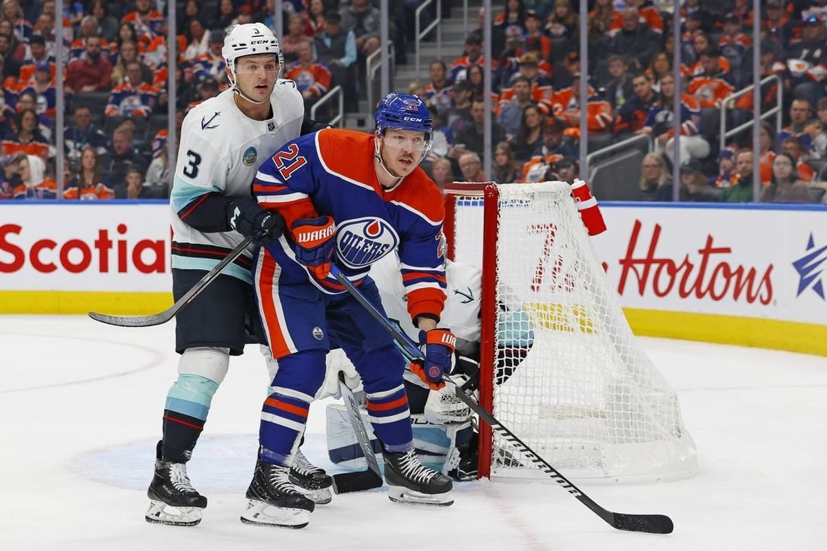 Oct 6, 2023; Edmonton, Alberta, CAN; Edmonton Oilers forward Adam Erne (21) battles for position with Seattle Kraken defensemen Will Borgen (3) in front of goaltender Philipp Grubauer (31) during the first period at Rogers Place.