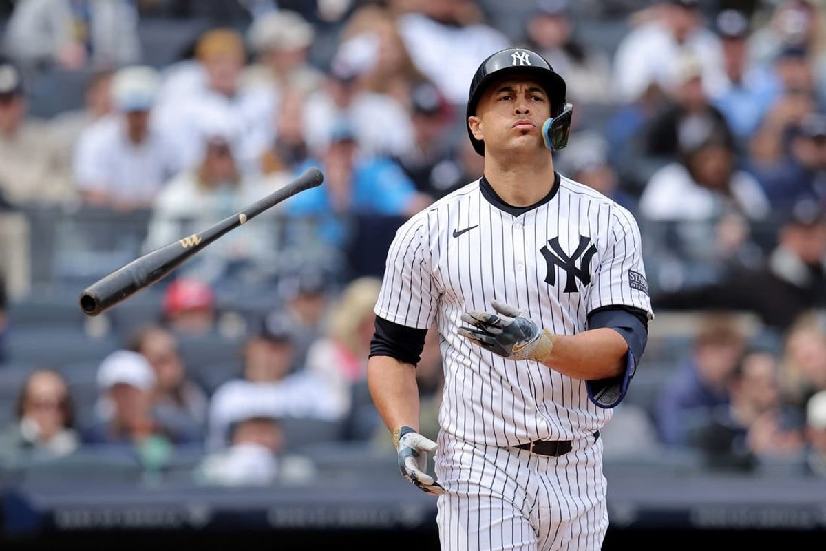 Apr 21, 2024; Bronx, New York, USA; New York Yankees designated hitter Giancarlo Stanton (27) tosses his bat after drawing a walk during the fifth inning against the Tampa Bay Rays at Yankee Stadium.
