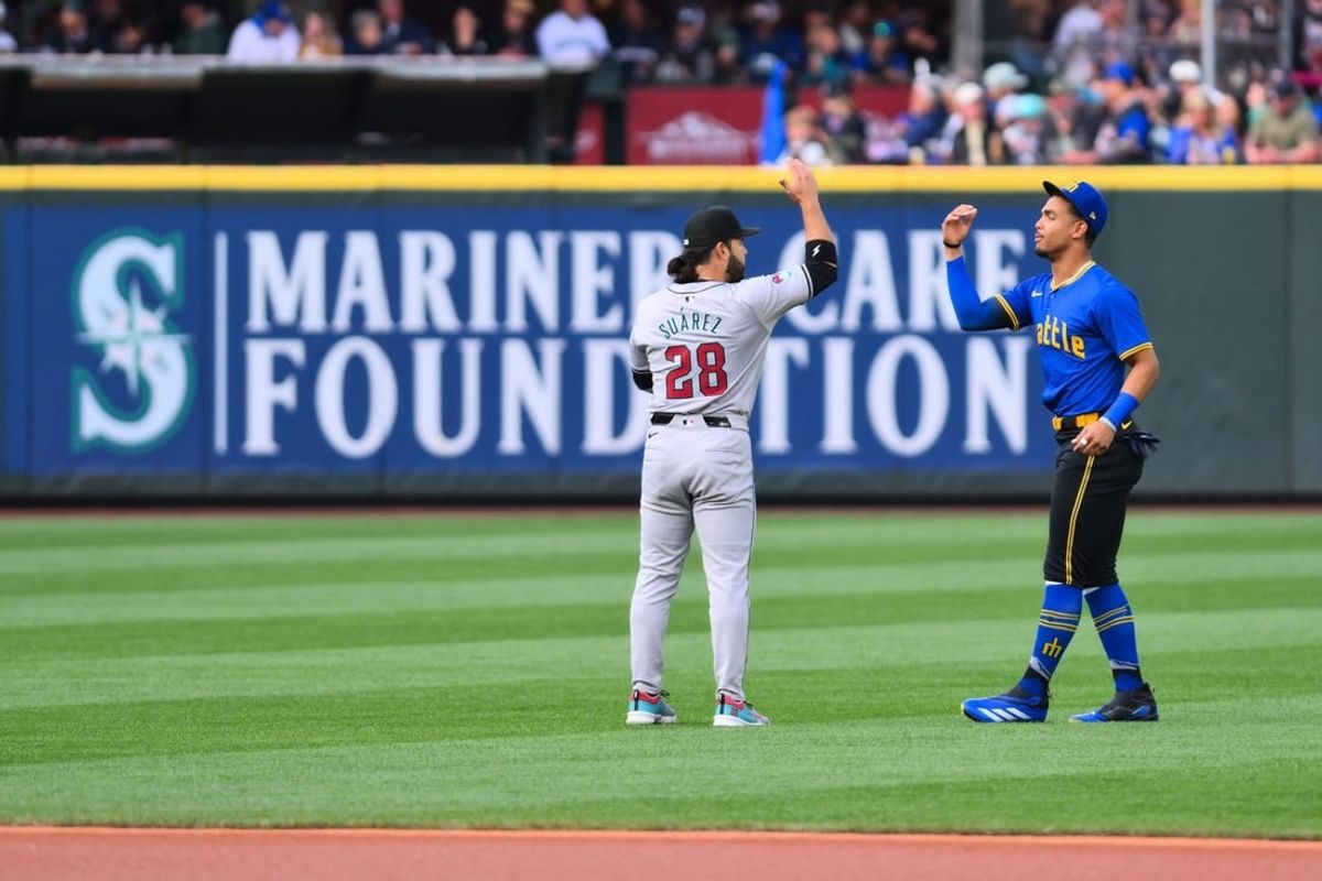 Apr 26, 2024; Seattle, Washington, USA; Arizona Diamondbacks third baseman Eugenio Suarez (28) and Seattle Mariners center fielder Julio Rodriguez (44) greet each other prior to the game at T-Mobile Park.